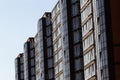 Architectural details of modern high apartment building facade with many windows and balconies Royalty Free Stock Photo