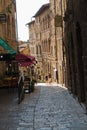 Architectural details of old houses and small restaurants at narrow and steep winding streets of Volterra, Tuscany