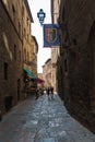 Architectural details of old houses and small restaurants at narrow and steep winding streets of Volterra, Tuscany