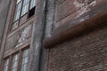 Architectural details of old industrial building, brick work with rusting roll up door Royalty Free Stock Photo