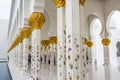 Architectural details of  White Grand Mosque built with marble stone against cloudy sky, also called Sheikh Zayed Grand Mosque in Royalty Free Stock Photo