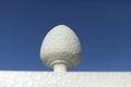 Architectural element egg. Fence detail. White sphere against sky