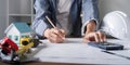 Architectural Engineer Designing Construction Plans with Calculation Tools