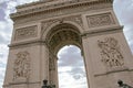 Architectural fragment of Arc de Triomphe du Carrousel, under sky with clouds in Paris.