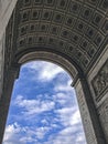 Architectural fragment of Arc de Triomphe du Carrousel, under sky with clouds in Paris.