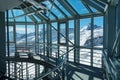Architectural glass and metal interior with snowy alpine vista - horizontal