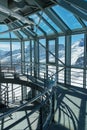 Architectural glass and metal interior with snowy alpine vista - vertical