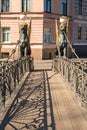 The architectural historical monument of the Hanging Bank Bridge with lions on the Griboyedov Canal in St. Petersburg on a sunny