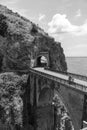 Architectural landmark, stone bridge. A view of the Fiordo of Furore in Amalfi coast, Motorcyclist on road. Travel and vacation