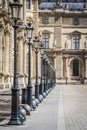 Architectural landscape of the alleys and lamps of the Place des Pyramides of the Louvre Museum in Paris Royalty Free Stock Photo