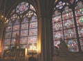 Praying Statue and Artistic Stained Glasses with Notre Dame Cathedral