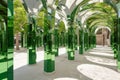 An architectural marvel, this image captures a series of archways with green-tinted mirrored columns reflecting a Royalty Free Stock Photo