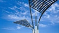 Architectural metal structures against a blue sky with dramatic clouds