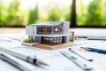 Architectural model with blueprints on desk