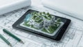 Architectural model displayed on tablet, showcasing sustainable design, complete with blueprints and pens Royalty Free Stock Photo