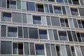 An architectural pattern of blue windows of different size