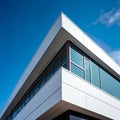 architectural photograph presents a close-up view of a modern glass and concrete building against the backdrop of the sky. Royalty Free Stock Photo