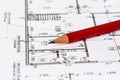 The architectural plan of the house is printed on a white sheet of paper. A red pencil on it.