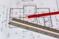 The architectural plan of the house is printed on a white sheet of paper. A red pencil and a ruler on it.