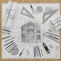 Architectural plans are nearby, and various drawing instruments, Royalty Free Stock Photo