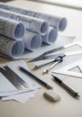 Architectural workspace with rolled-up blueprints, ruled paper, and drafting tools. Items Royalty Free Stock Photo