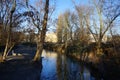 Bridge over the Wuhle River with the sun reflecting on the water. Berlin, Germany