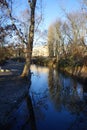 Bridge over the Wuhle River with the sun reflecting on the water. Berlin, Germany