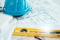 Architecture, blueprint and plan, construction and helmet, engineering design and drawing with level closeup Royalty Free Stock Photo