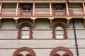 Architecture of brick outlined windows and wooden balcony