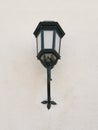 Exterior antique lamp on stone facade. Bottom view of vintage iron lantern. Architecture and construction