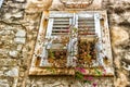 Architecture of Croatia: windows and geranium Royalty Free Stock Photo