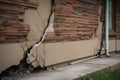 Architecture detail of damaged house dilapidated old building wall. Private abandoned home fall to ruin. Consequences of Royalty Free Stock Photo