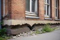 Architecture detail of damaged house dilapidated old building wall. Private abandoned home fall to ruin. Consequences of Royalty Free Stock Photo