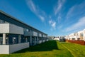 Architecture detail of modern apartment building exterior with grass and blue sky Royalty Free Stock Photo