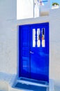 Architecture details of ancient building with blue door, Santorini island, Greece Royalty Free Stock Photo