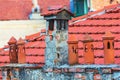 Architecture details of the house with old chimneys and tile roof on the background Royalty Free Stock Photo