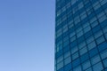 Architecture details of modern building with glass facade on blue sky background. Royalty Free Stock Photo