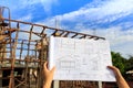 architecture drawings in hand on house building ba