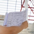 Architecture drawings in hand on house building background