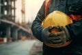 Architecture engineer holds hard hat for construction safety, professional Royalty Free Stock Photo