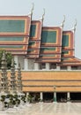 Architecture exterior of the chapel with Gable apex roof and Chinese stone sculptures against blue sky at the famous Wat Suthat Royalty Free Stock Photo