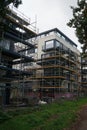 Scaffolding surrounds a residential apartment building under construction. Berlin, Germany