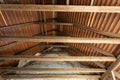 Inside an old house looking upside at the ancient wooden roof framework