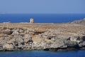 View of the old windmill on the coast of Lindos in August. Lindos, Rhodes Island, Dodecanese, Greece Royalty Free Stock Photo