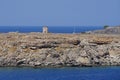 View of the old windmill on the coast of Lindos in August. Lindos, Rhodes Island, Dodecanese, Greece Royalty Free Stock Photo