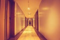 Architecture long walkway or footpath inside building of hotel flanked with wooden door and wall. Royalty Free Stock Photo