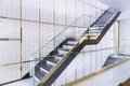 Luxury wooden staircase with glass railing and gold handrail in golden grille house interior Royalty Free Stock Photo