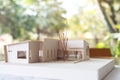 An architecture model with shop drawing paper on table in office with blur nature Royalty Free Stock Photo