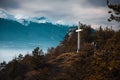 Architecture observation lookout point structure in Razlog, Bulgaria. White cross statue in Autumn through tree branch. Royalty Free Stock Photo