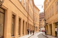 The architecture of the old city of Prague. The figure of a man hanging on one arm above the street Royalty Free Stock Photo